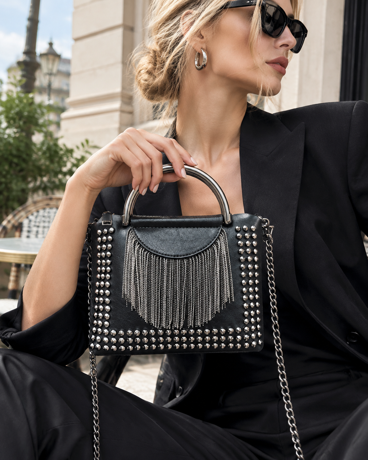 Noir Cascade Handbag: matte black studded handbag with a waterfall of metal fringe, a chunky ring handle and a curb-chain strap